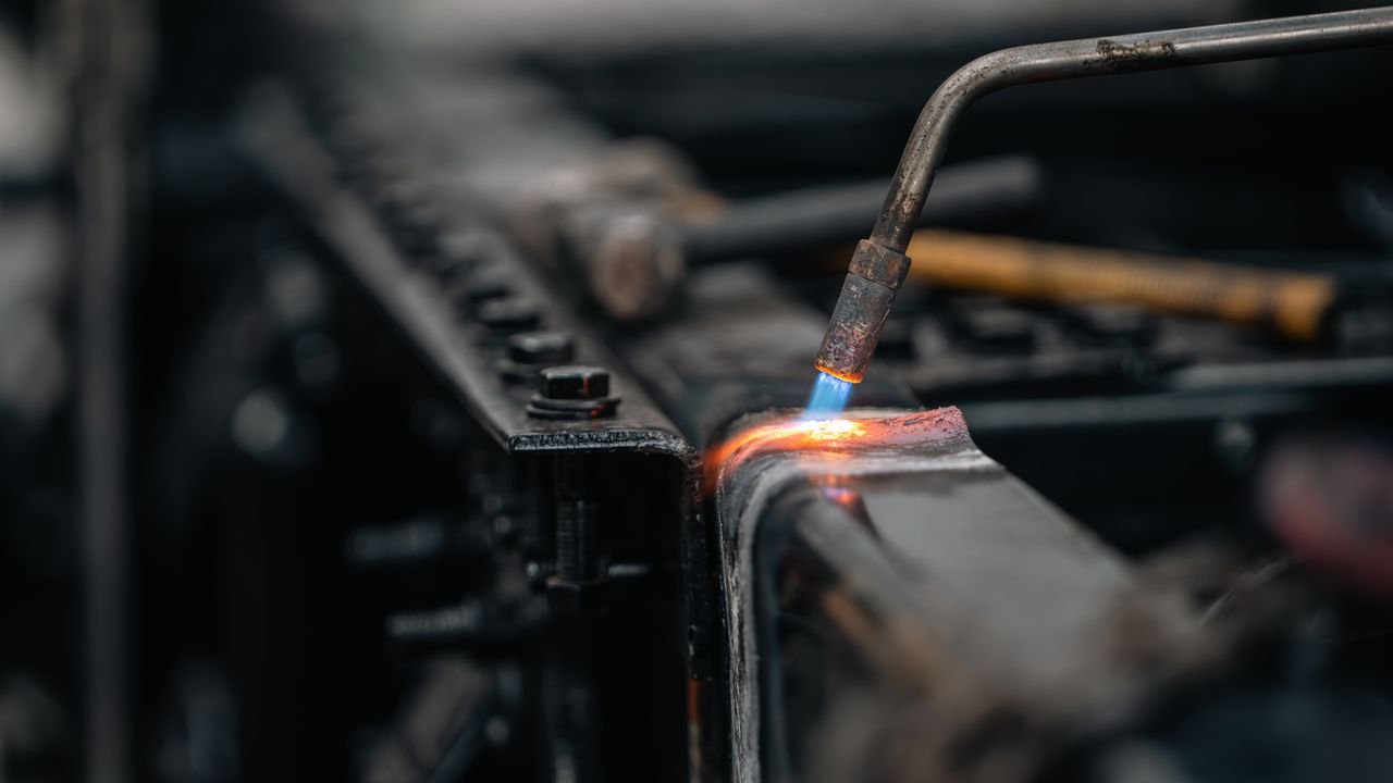 The Art of Drawing Readers In: Your attractive post title goes here Detailed view of torch welding metal surface, featuring blue flame.